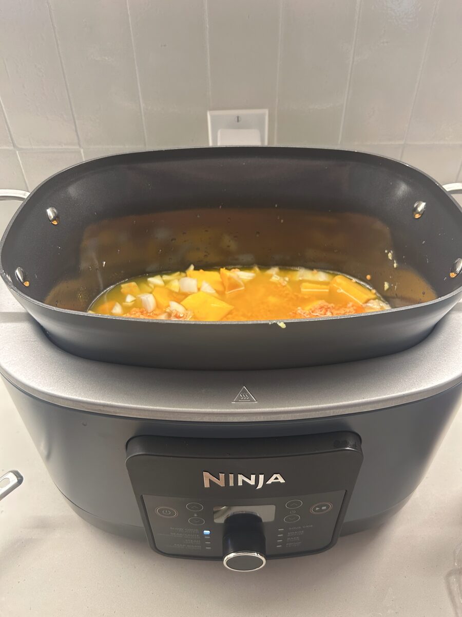 Soup with butternut squash, onion, and lentils cooking in the slow cooker